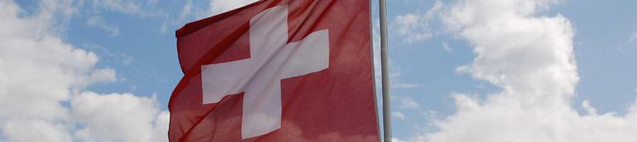 A Swiss flag is flying in the wind